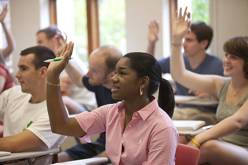 Female student raising hand in a classroom