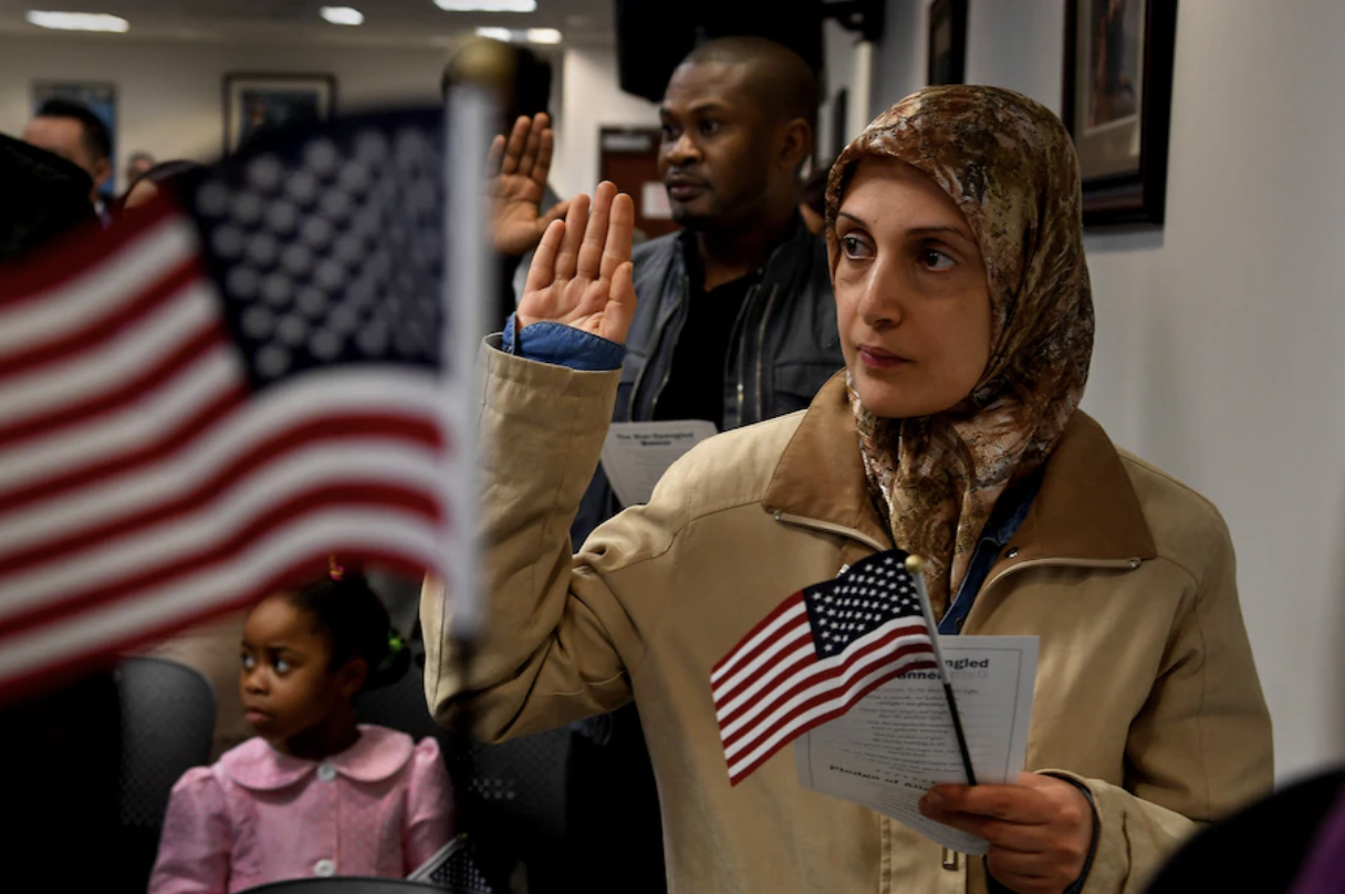 Rafeef Hammad, originally from Iraq, takes the citizenship oath with 35 other new U.S. citizens in Fairfax, Va., in January 2017. (Michael S. Williamson/The Washington Post)