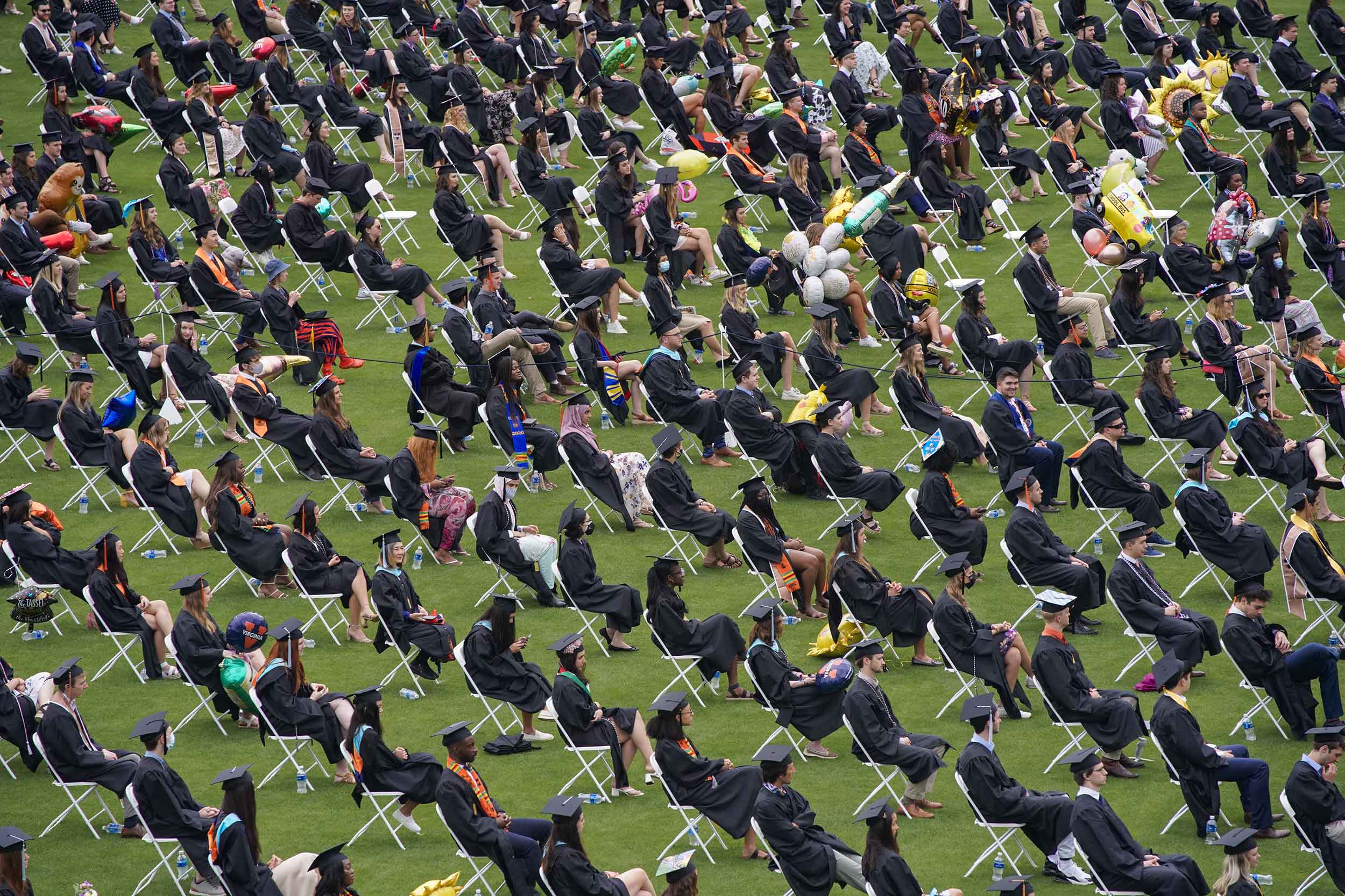 Graduates filled rows of chairs on the field, spaced apart in compliance with public health guidelines. (Photo by Sanjay Suchak, University Communications)